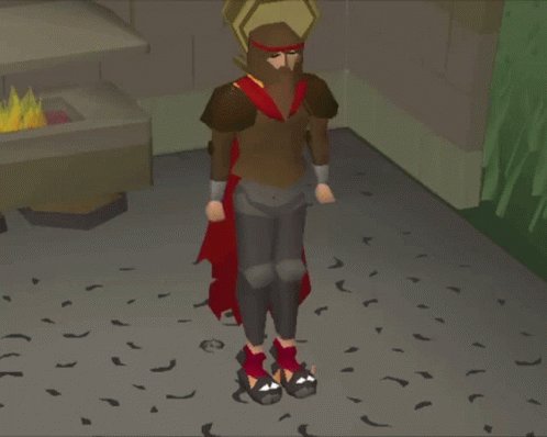 The image features a man dressed as a Roman soldier, standing on a gray floor with his arms crossed over his chest. He is wearing a brown outfit that includes a red cape, which adds an element of fantasy to his character portrayal. The background shows a brick wall and a fire pit, suggesting the setting could be a historical or medieval-themed game or event.