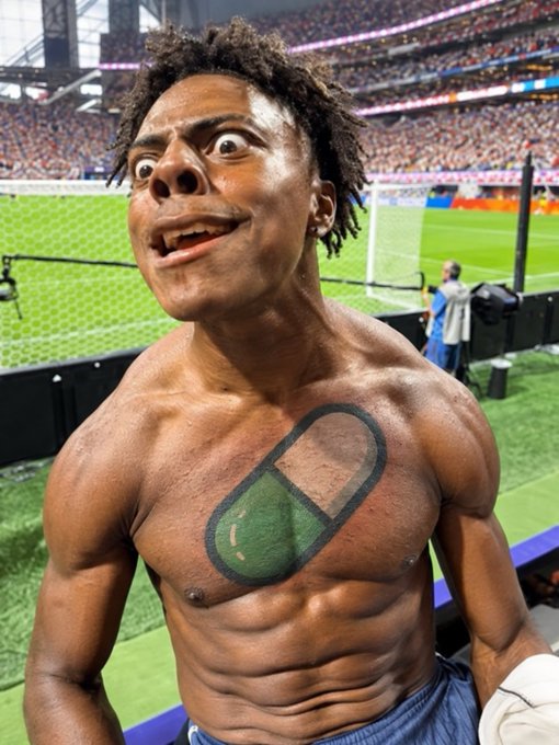 A muscular man stands shirtless in a stadium with an exaggerated, wide-eyed expression; his chest is digitally altered to feature a large painted pill capsule instead of his natural anatomy.
