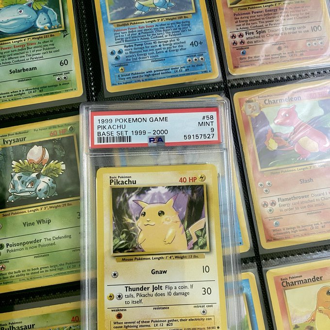A collection of vintage Pokemon cards featuring a prominently displayed PSA-graded '1999 POKEMON GAME PIKACHU #58 MINT 9' card alongside other holographic cards like Venusaur, Ivysaur, Squirtle, Charmeleon, and Charmander.