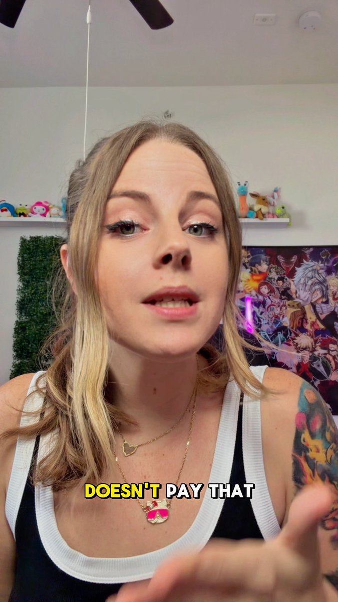 A young woman with blonde hair, wearing a black and white top and Poké Ball necklaces, speaks to the viewer with the caption 'DOESN'T PAY THAT' displayed across her chest.