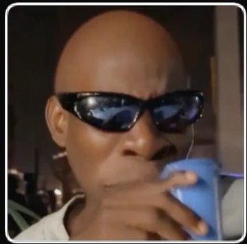 A close-up meme image of Morpheus from The Matrix wearing sunglasses while sipping from a blue cup, commonly used as a reaction image.