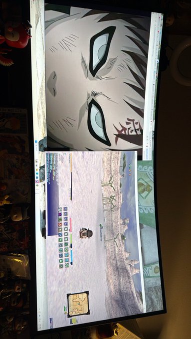 A photo shows a dual-monitor computer setup displaying an anime-style face on one screen and a Minecraft game on the other.