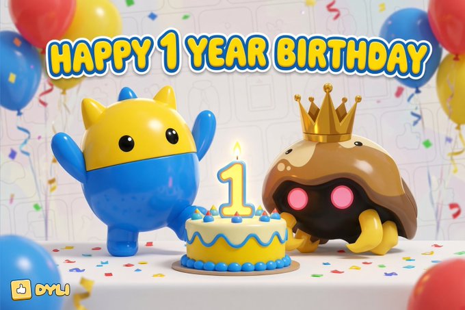 A 3D-rendered birthday scene showing a blue and yellow cat-like character and a chocolate-donut creature wearing a crown next to a cake with a '1' candle, captioned 'HAPPY 1 YEAR BIRTHDAY' with the OYLi logo.