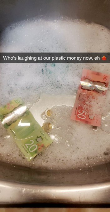 urn of water with soap bubbles, two Canadian 20-dollar bills floating on the surface.