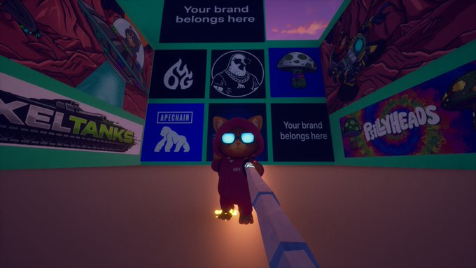 A cat character in a red hooded suit stands in a virtual game environment surrounded by sponsor panels for "Xeltanks," "Apechain," "BillyHeads," and other brands, promoting an upcoming gaming event at Nexus.