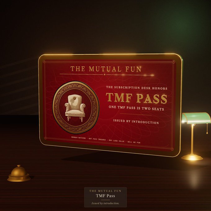 An image of 'THE MUTUAL FUN TMF PASS', a decorative red and gold membership card stating 'ONE TMF PASS IS TWO SEATS', displayed on a desk next to a small lamp.