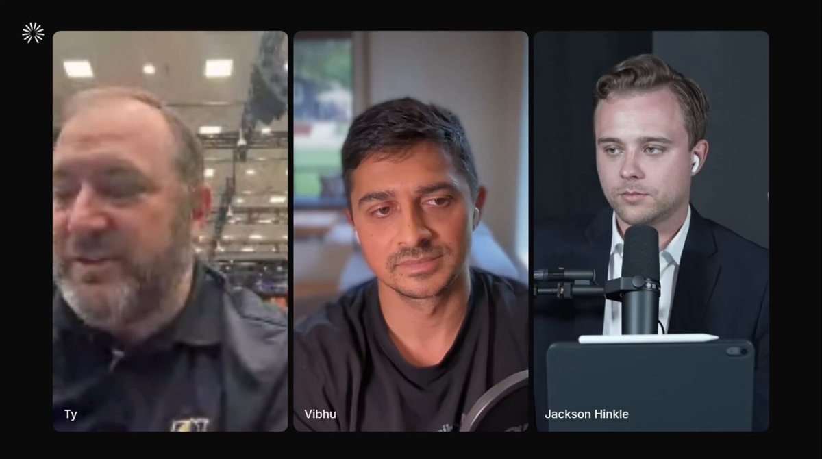 The image shows three men sitting behind a desk, each holding a microphone. They are all wearing suits and appear to be engaged in a conversation or presentation. The background features a black screen displaying the text "@WSOP". This suggests that they might be discussing business matters related to the @WSOP chain of restaurants.