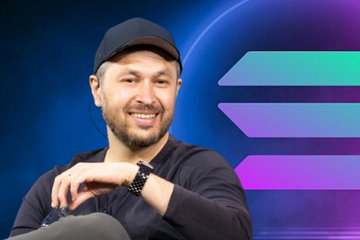 The image features a man wearing a black hat, sitting down with his hands resting on his lap. He has a smile on his face as he looks directly at the camera. The background of the image is blue, which contrasts nicely with the purple and green elements in the foreground. In the background, there are three lines that appear to be arrows pointing towards the man's head. These arrows have different colors: one arrow is purple, another is green, and the third is blue. The text "Solana" can also be seen in the image.