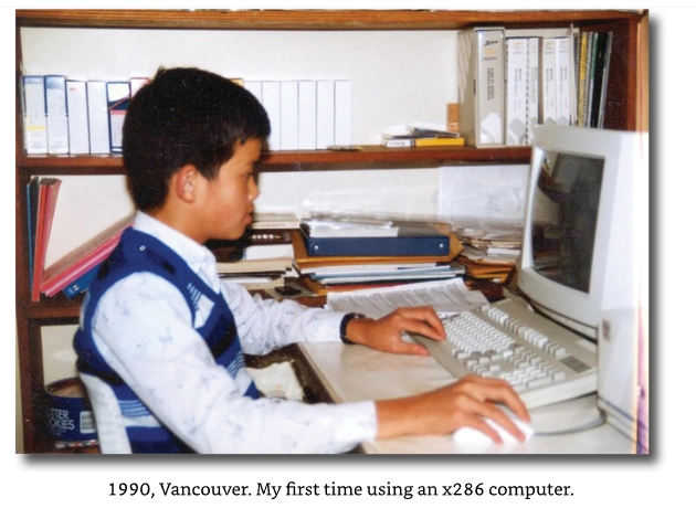 A vintage photograph showing a young boy sitting at a desk using an x286 computer; the caption below reads '1990, Vancouver. My first time using an x286 computer.'