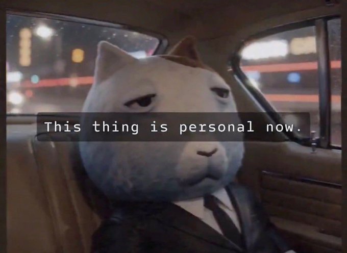 A serious-looking white cat in a suit sits inside a car with the caption "This thing is personal now." overlaid, humorously conveying an investor's vengeful determination after "bought more ket," suggesting a personal vendetta against the market.