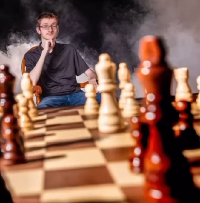 A young man in glasses thoughtfully stares down a chessboard, appearing deep in calculation amid smoky, moody lighting. The image nostalgically evokes the "old CT" atmosphere of competitive, strategic banter—contrasted with the post's joke about the community now devolving into clout-chasing rather than genuine mental warfare.