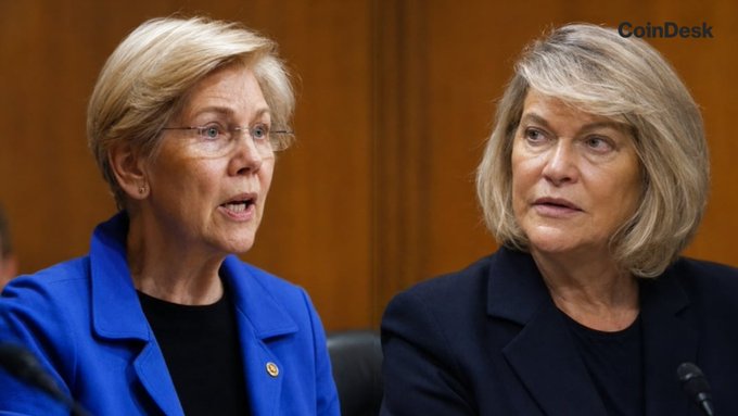 The image shows Senator Elizabeth Warren (left) and Senator Cynthia Lummis (right) seated together, both appearing engaged in a serious discussion. The "CoinDesk" watermark is visible in the upper right corner.

The image relates to the post by showing the two senators at the center of the public clash over the CLARITY Act's ethics provision, with Warren's office criticizing the bill's crypto-related ethics loopholes and Lummis defending her legislation.