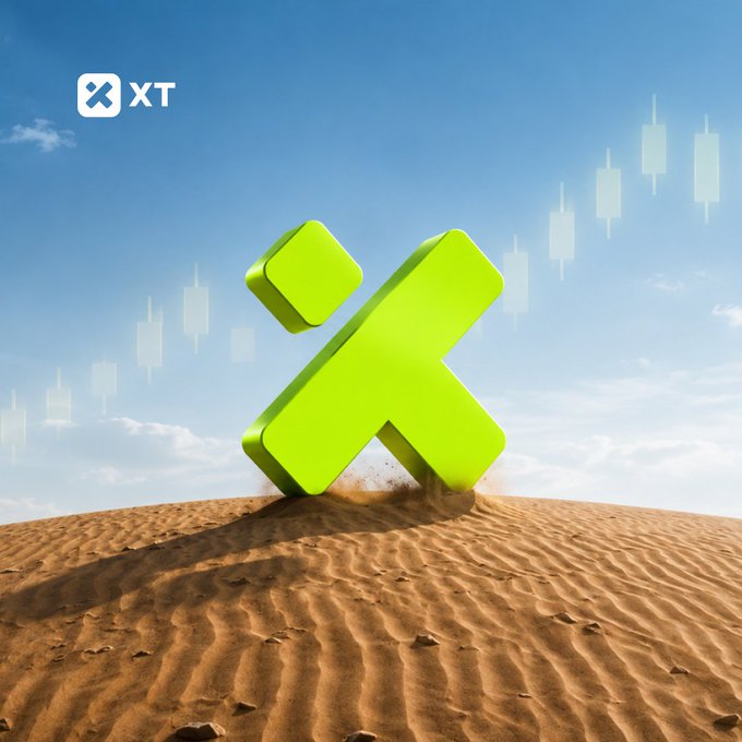 A promotional graphic for XT cryptocurrency shows a bright green 3D X logo half-buried in a sandy desert dune beneath a blue sky, with faint candlestick chart graphics in the background.