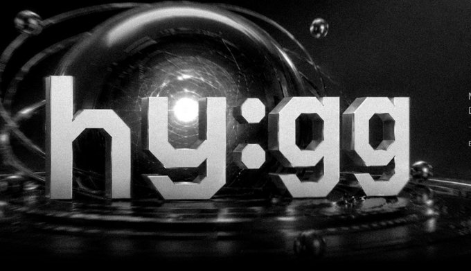 A black-and-white digital render displays the text "hy:99" in front of a large sphere surrounded by orbiting rings.