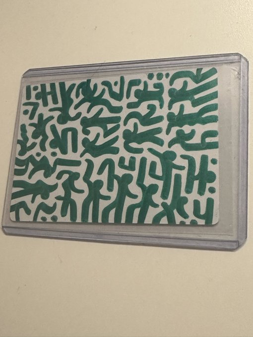 An artwork titled 'Splitting' featuring a dense, maze-like pattern of dark green abstract squiggles and shapes on a light background, framed within a grey border.