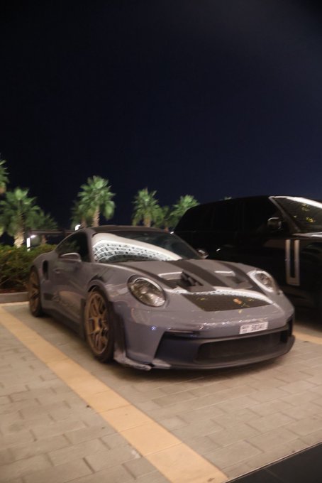 A gray Porsche 911 GT3 with bronze wheels and a carbon fiber hood is parked at night next to a black SUV, with palm trees visible in the background.

The "GN if you GN" caption ("GN" meaning "good night") pairs with the image as a casual nighttime sign-off, with the parked Porsche setting the scene for the end of the day.