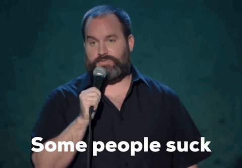 The image features a man with a beard holding a microphone, standing against a dark background. The caption of the image reads "Some people suck", which seems to be a reference to a humorous statement or joke about people who are not good enough for others' standards. The post also mentions that the man is using a Quantum resistant account and that he has tied it to a specific quote from another post, likely on Quipnetwork.