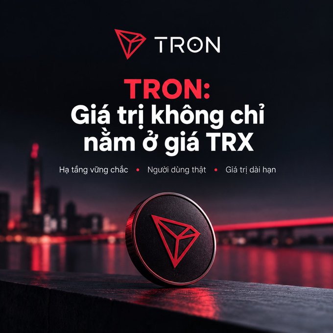 A promotional graphic for the TRON cryptocurrency shows a physical TRX coin resting on a ledge with a red-lit city skyline in the background, featuring Vietnamese text 'TRON: Giá trị không chỉ nằm ở giá TRX'.