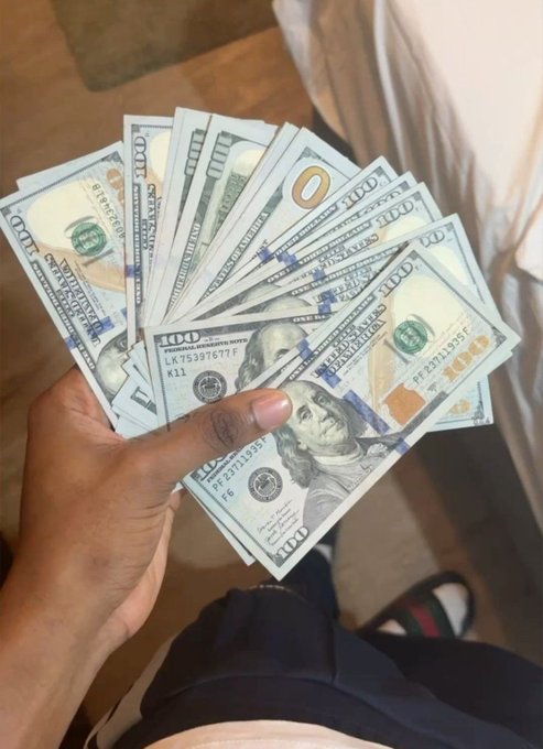 A hand fans out a handful of $100 U.S. bills, displaying the distinctive Benjamin Franklin design and Federal Reserve markings, perfectly visualizing the "Who's ready to make money today?" caption as a tangible display of cash wealth.