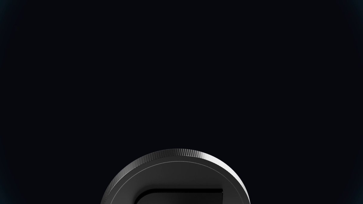 The image features a grey background with an upside down coin resting at the bottom right corner. A message overlay reads "Trade $SNDK on Jupiter Mobile @SanDisk a global semiconductor leader and breakout name in AI-memory is now onchain via @sunrisedefi @sandisks". The text emphasizes a promotion for the trading of a specific item or service, which seems to be related to a phone company. It is placed above the coin image, creating an eye-catching presentation for viewers who may want to learn more about this offer and how it works.
