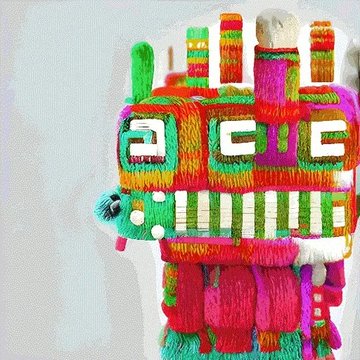 A colorful, vibrantly textured llama-shaped piñata or craft featuring bright pink, green, orange, and red yarn in traditional Andean designs.