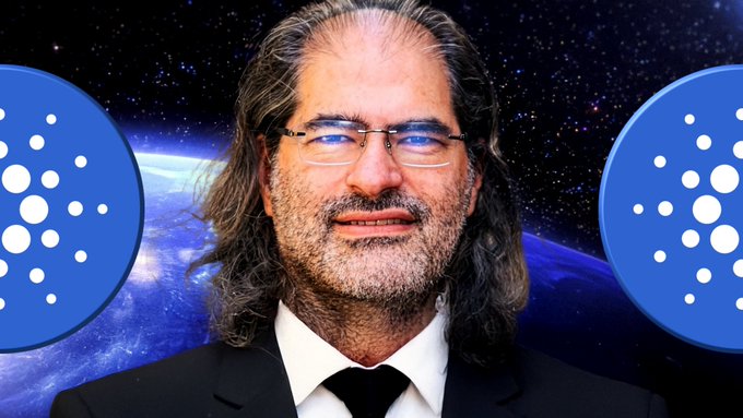 The image features a man wearing glasses, a suit, and a tie standing against a backdrop of stars and planets. The man appears to be smiling at the camera. Below him are two blue circles with white dots, which appear to be logos or icons related to Bitcoin or cryptocurrency. The text "Daily Cardano News! Charles: Pogun To Unleash $XRP !" targets TVL Growth! youtu.be/f4Xh5w9_Kvs" is also present in the image.