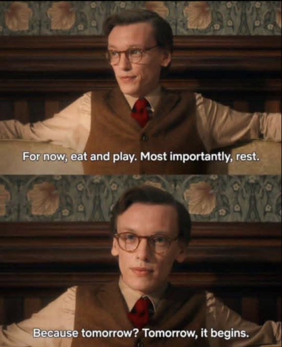 A man with glasses in a vest and tie sits against a floral wallpaper background, with subtitles reading "For now, eat and play. Most importantly, rest." and "Because tomorrow? Tomorrow, it begins." The image connects to the post "GN CT" (Goodnight, Connecticut) by mirroring the phrase "tomorrow it begins," suggesting a reflective send-off before a new day or chapter starts.