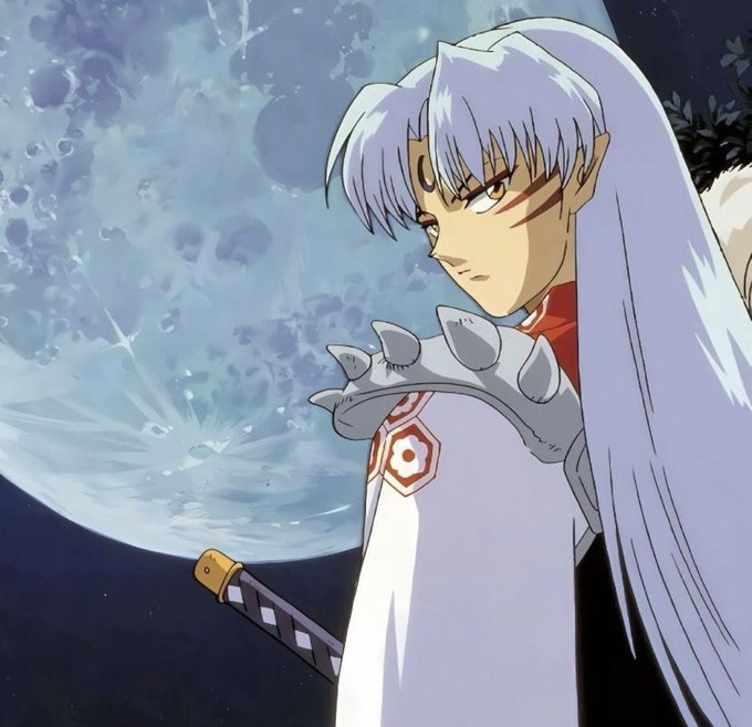 Anime character Sesshomaru from Inuyasha stands in profile against a large moon, wearing his signature white kimono with red hexagon patterns and spiked shoulder armor, while holding the hilt of his sword. The "GM" (Good Morning) post pairs well with this iconic shot of the stoic demon lord gazing thoughtfully under the moonlight.