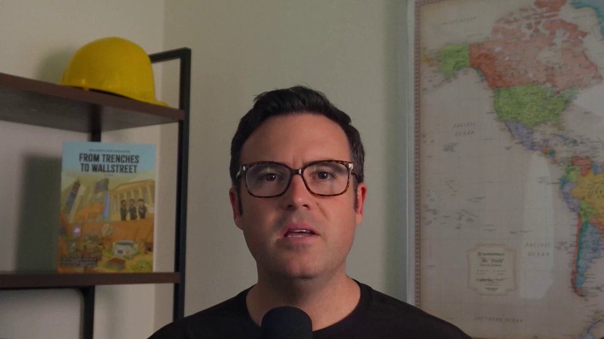 A man wearing glasses stands against a white wall with a map of South America above him and a book titled "From trenchcoats to Wall Street" nearby. The title of the book suggests an ongoing conversation about financial topics, particularly native staking in cryptocurrency trading platforms like @Solana DeFi. The post also mentions Solana DeFi's $INF yield as it relates to native staking within its ecosystem, potentially offering a new perspective on how investors might approach trading and investing strategies.