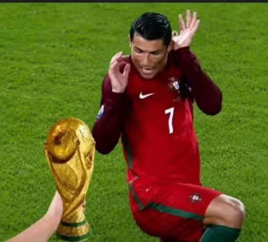 Cristiano Ronaldo in his Portugal #7 jersey performs his signature 'Siu' celebration next to the FIFA World Cup trophy on a soccer field.