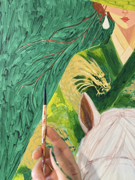 An oil painting in progress, showing a hand holding a fine brush painting green textured strokes next to depictions of a woman's face, an ear, and a dragon head.