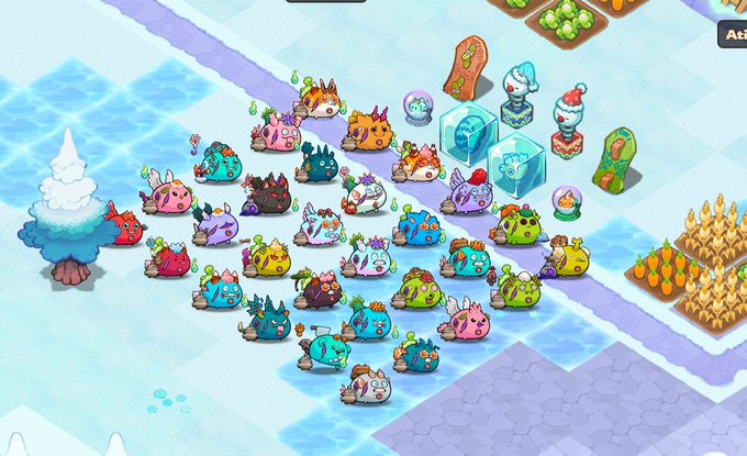 A screenshot of the Terrarium game displays a diverse collection of colorful, chubby NFT creatures gathered on a snowy tile terrain, alongside farm plots, ice blocks, and decorative statues. The visual perfectly captures the post's description, showing how the game functions as a lively, animated showcase for displaying and organizing an NFT collection.
