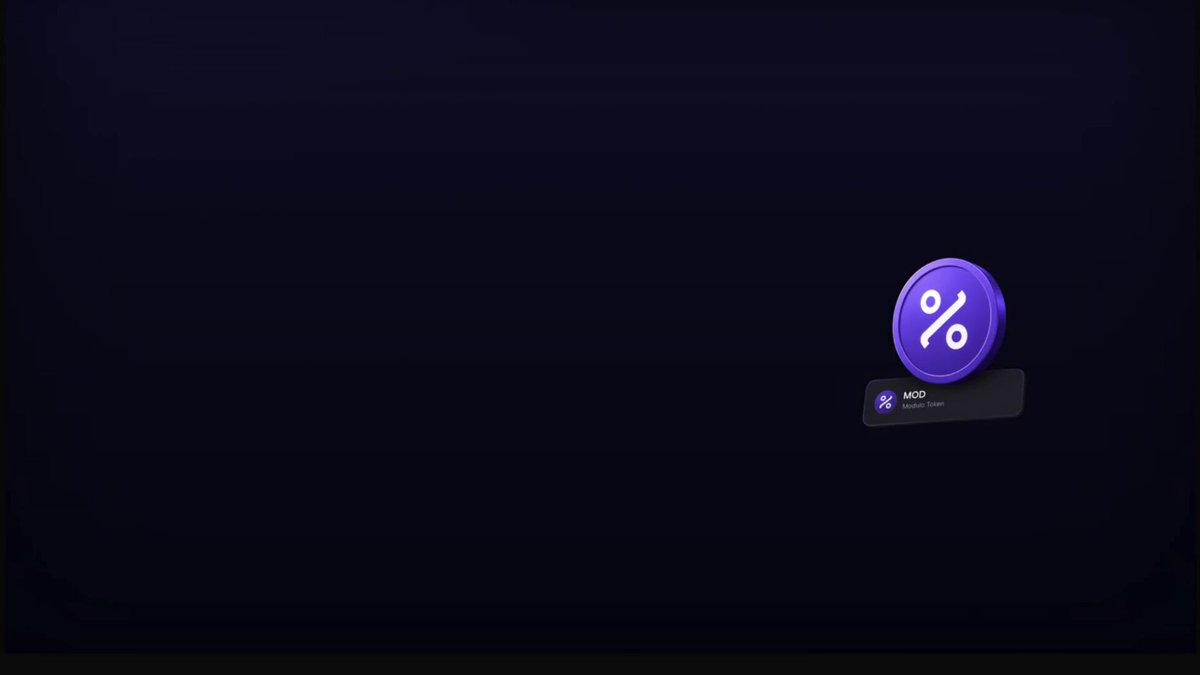 The image features a purple button with a percentage symbol (%), which has been pushed down onto a dark blue background. The text "Modulo" is also present, indicating that this is related to Modulo token functionality. The image includes a caption that reads "Focus on what is in the image and how it relates to the post."