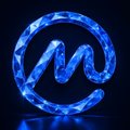 A glowing blue circular logo with an abstract wave-like design in the center on a black background.