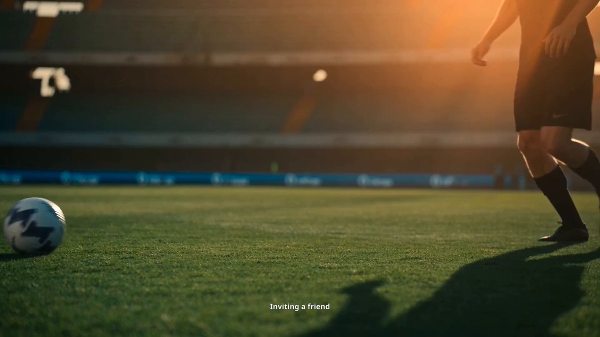 The image depicts a person running across a soccer field, preparing to kick a ball that is positioned near them. The background of the photo shows an empty stadium with several stands visible in the distance, creating an atmosphere of anticipation and excitement for the upcoming game. A promotional text appears at the bottom of the image, encouraging viewers to "giving a friend" or be part of the giveaway process, which offers 500 USDT for someone who submits their contact information via the provided forms. This is likely related to the advertisement campaign for an air show featuring soccer and aviation, emphasizing the connection between sports and other industries.