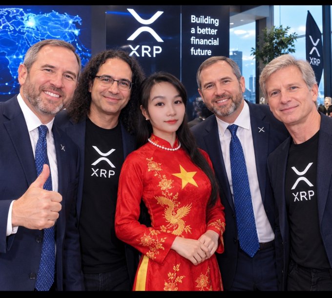Brad Garlinghouse, Ripple's CEO, and other team members pose for a photo with a woman in a traditional Vietnamese áo dài in front of an XRP banner reading 'Building a better financial future.'
