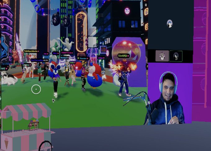 A gamer with headphones reacts to a colorful virtual world game with cartoon avatars on screen.