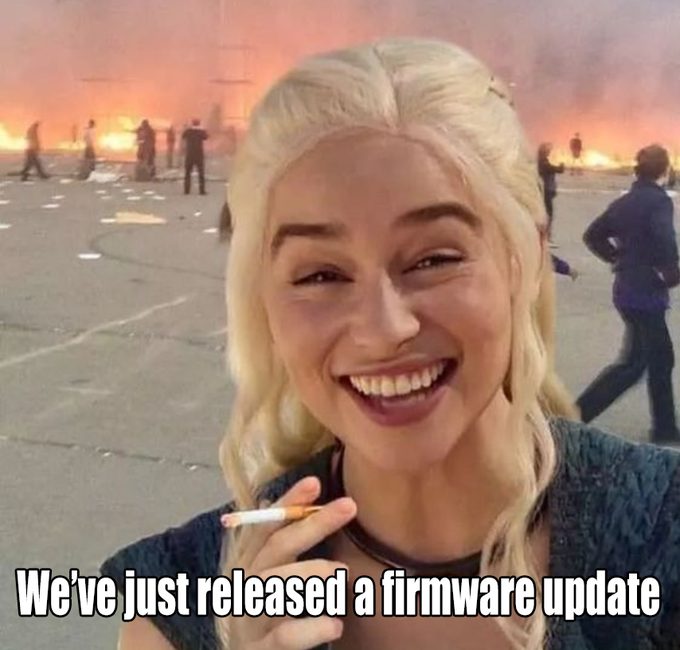 The 'happy girl in burning building' meme featuring Daenerys Targaryen (Emilia Clarke) smiling and holding a cigarette, with the caption 'We've just released a firmware update'.