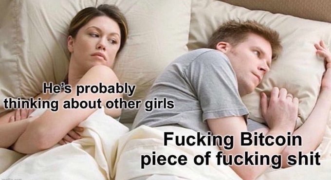 The image features a couple lying in bed, with one person looking at the camera while the other looks away. Below them, there's text that reads "He's probably thinking about other girls", which suggests that they might be discussing relationships or personal matters. The text also mentions "Fucking $BTC piece of fucking shit" and implies that someone is making a joke about Bitcoin.