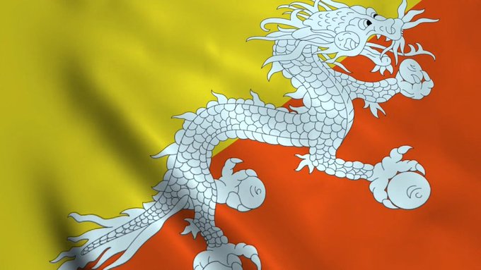 The image shows the flag of Bhutan, featuring a white dragon clutching jewels on a diagonally divided yellow and orange background. The post's reference to Bhutan selling $BTC likely alludes to the country's reported holdings of Bitcoin, with the dragon symbolizing the nation's mythical wealth and strength.