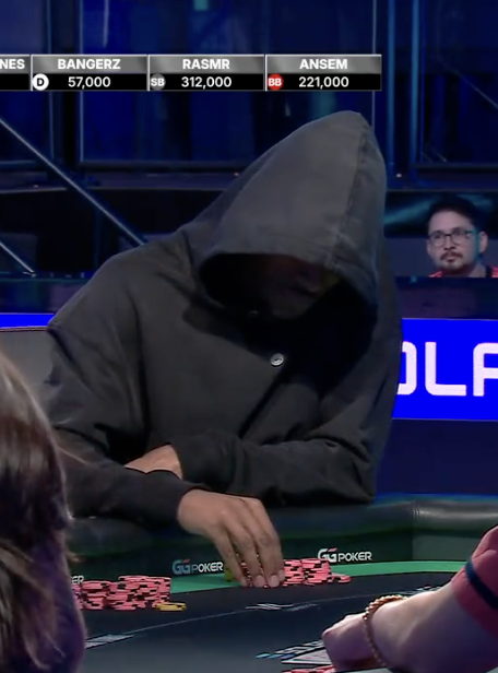 A hooded poker player leans over the table with chips in hand during a high-stakes televised game, with a leaderboard showing BANGERZ at 57,000, RASMR at 312,000, and ANSEM at 221,000 — fitting the post's "All in on $ANSEM" reference to the player currently leading in second place.