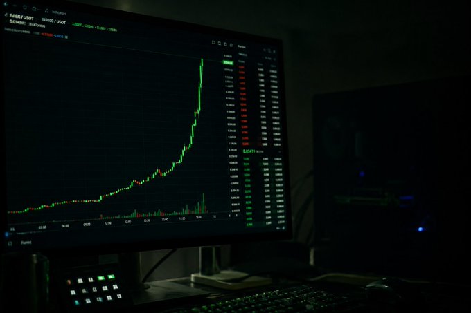 A monitor displays a candlestick chart for the A48/USDT trading pair on DEX48 with ShortMax, showing a dramatic upward price spike in a dark room setup. The chart's explosive price action visually mirrors the post's excitement about $PONS hitting another ATH and the growth of tokenized stocks like NVDA 3x leverage tokens on platforms like Robinhood Chain.