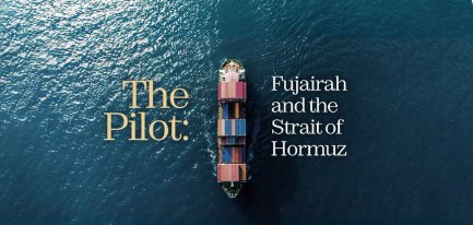 An aerial view of a cargo ship on blue water with the text 'The Pilot: Fujairah and the Strait of Hormuz.'