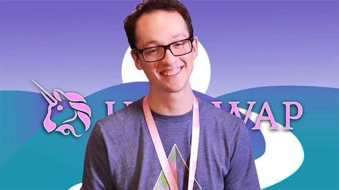 A smiling man with glasses and a lanyard stands in front of a 'UNI SWAP' branded backdrop featuring a unicorn logo.