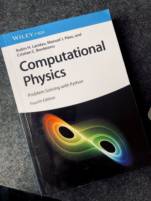 The image features a book titled "Computational Physics" with an orange circle design at the top of its spine. The book appears to be open and placed on a table or desk, suggesting that someone has recently been reading or studying from it. The focus of the image is on the content of the book rather than any additional objects in the scene.