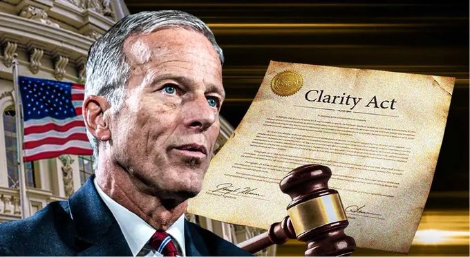 A political image showing a gray-haired man in a suit next to a US flag, with a 'Clarity Act' document and a judge's gavel in the foreground.