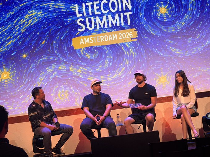 A panel of four speakers sits on a stage with a Van Gogh Starry Night-style backdrop at the 'LITECOIN SUMMIT AMSTERDAM 2026'.