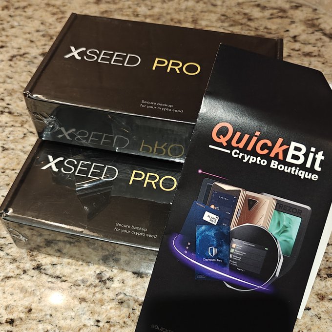 Two black boxes labeled 'XSEED PRO - Secure backup for your crypto seed' are displayed next to a 'QuickBit Crypto Boutique' informational card.