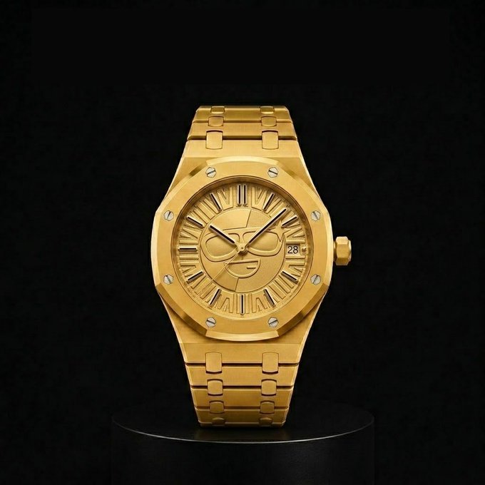 A gold luxury wristwatch displayed on a black pedestal against a dark background, featuring an octagonal bezel with screws, an integrated bracelet, and a stylized face design on the dial.