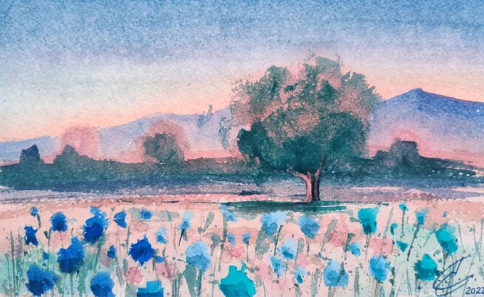 A watercolor painting titled "The Lone Tree of the Plain" by @Naz_BaharArt (signed 2021) depicts a solitary tree standing in a field of blue wildflowers at sunset, with soft pastel pinks and purples in the sky behind distant mountains. The artwork, now live on artcollect.io for offers, captures the serene beauty of the lone tree framed by delicate blooms and a dreamy dusk landscape.